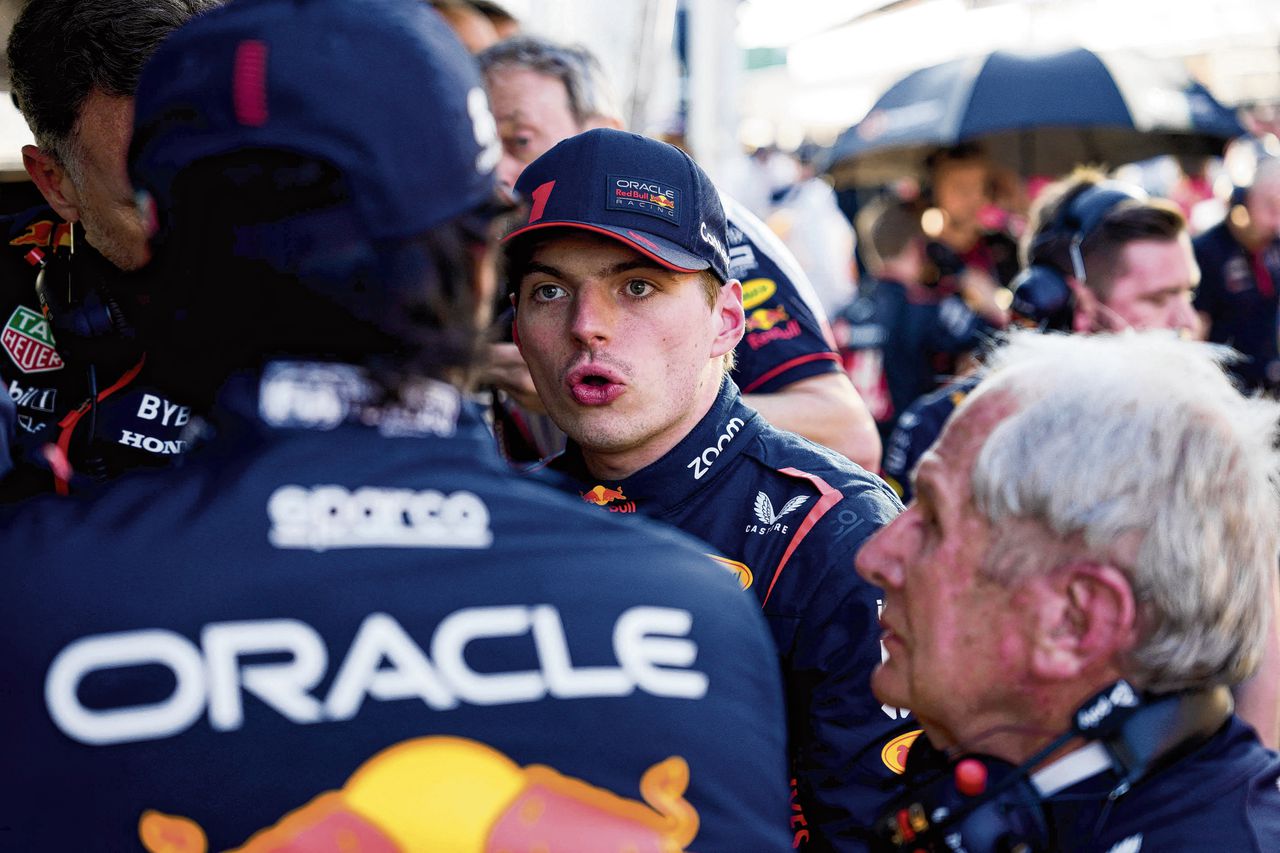 Max Verstappen (midden) in gesprek met zijn teamgenoot bij Red Bull Racing Sergio Pérez (links, op de rug gezien) tijdens een van de pauzes bij de Grote Prijs van Australië, in Melbourne.