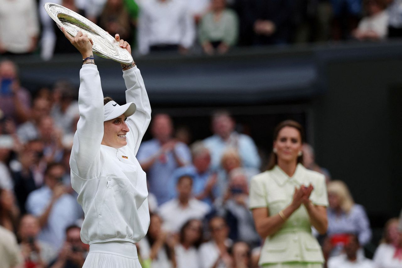 De Tsjechische Markéta Vondrousova houdt de Venus Rosewater Dish omhoog nadat zij op Wimbledon heeft gewonnen van de Tunesische Ons Jabeur.