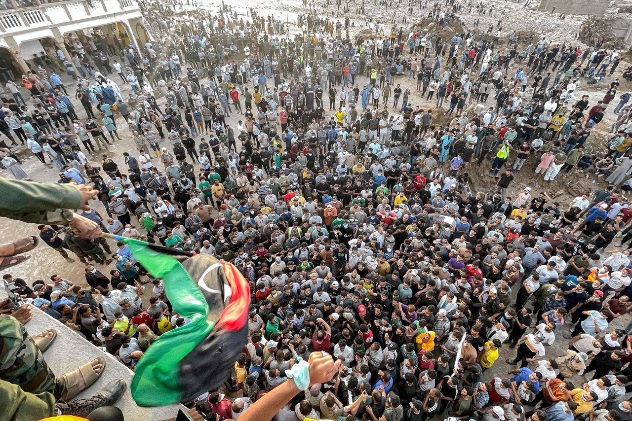 Demonstranten protesteren voor en op een moskee in Derna.