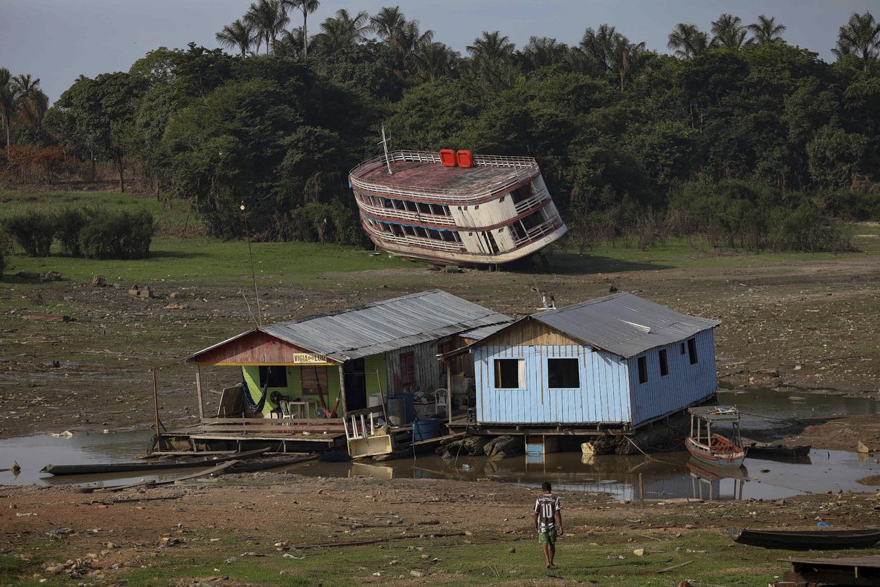 Houseboats and a stranded boat are seen on the Rio Negro, in the Cacau Pirera District, in Iranduba, Amazonas, Brazil, on September 25, 2023. The Government of Amazonas declared a State of Environmental Emergency on September 12 due to the high number of fires and a strong drought in the rivers, affecting navigation and food distribution to the interior of the state.