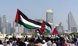 Betogers zwaaien met Palestijnse vlaggen tijdens een demonstratie in de Qatarese hoofdstad Doha op 20 oktober. 