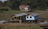 Houseboats and a stranded boat are seen on the Rio Negro, in the Cacau Pirera District, in Iranduba, Amazonas, Brazil, on September 25, 2023. The Government of Amazonas declared a State of Environmental Emergency on September 12 due to the high number of fires and a strong drought in the rivers, affecting navigation and food distribution to the interior of the state.