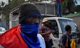 Demonstranten gaan in Port-au-Prince de straat op te eisen dat premier Henry aftreedt.