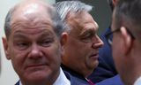 De Duitse bondskanselier Olaf Scholz (links) op de EU-top in Brussel. Achter hem de Hongaarse premier Viktor Orbán. 