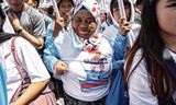 Indonesiërs onderweg naar het presidentieel paleis in Jakarta op de dag van de inauguratie van Prabowo, 20 oktober. Foto Oscar Siagian / Getty Images