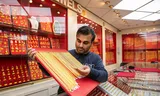 Gianni Khelawan laat gouden kettingen zien die hij verkoopt in Cleopatra Jewels in Rotterdam. 