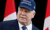 Doug Ford, premier van  Ontario,  met een honkbalpet met het motto ‘Canada is niet te koop’. Foto Blair Gable / Reuters 