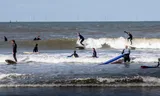 Het aantal golfsurfers neemt toe, zoals hier aan de kust van Scheveningen.  „Toch gaat iedereen met een glimlach het water in.”