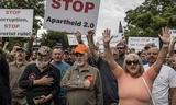 Witte Zuid-Afrikanen die de Amerikaanse president Donald Trump en de Zuid-Afrikaanse en Amerikaanse tech-miljardair Elon Musk steunen, verzamelen zich voor de Amerikaanse ambassade in Pretoria voor een demonstratie. Foto MARCO LONGARI/AFP 