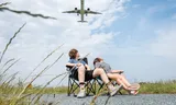 De kinderen van vliegtuigspotter John hopen een glimp op te vangen van de Air Force  One, het toestel van de Amerikaanse president. Foto Sonny Lensen